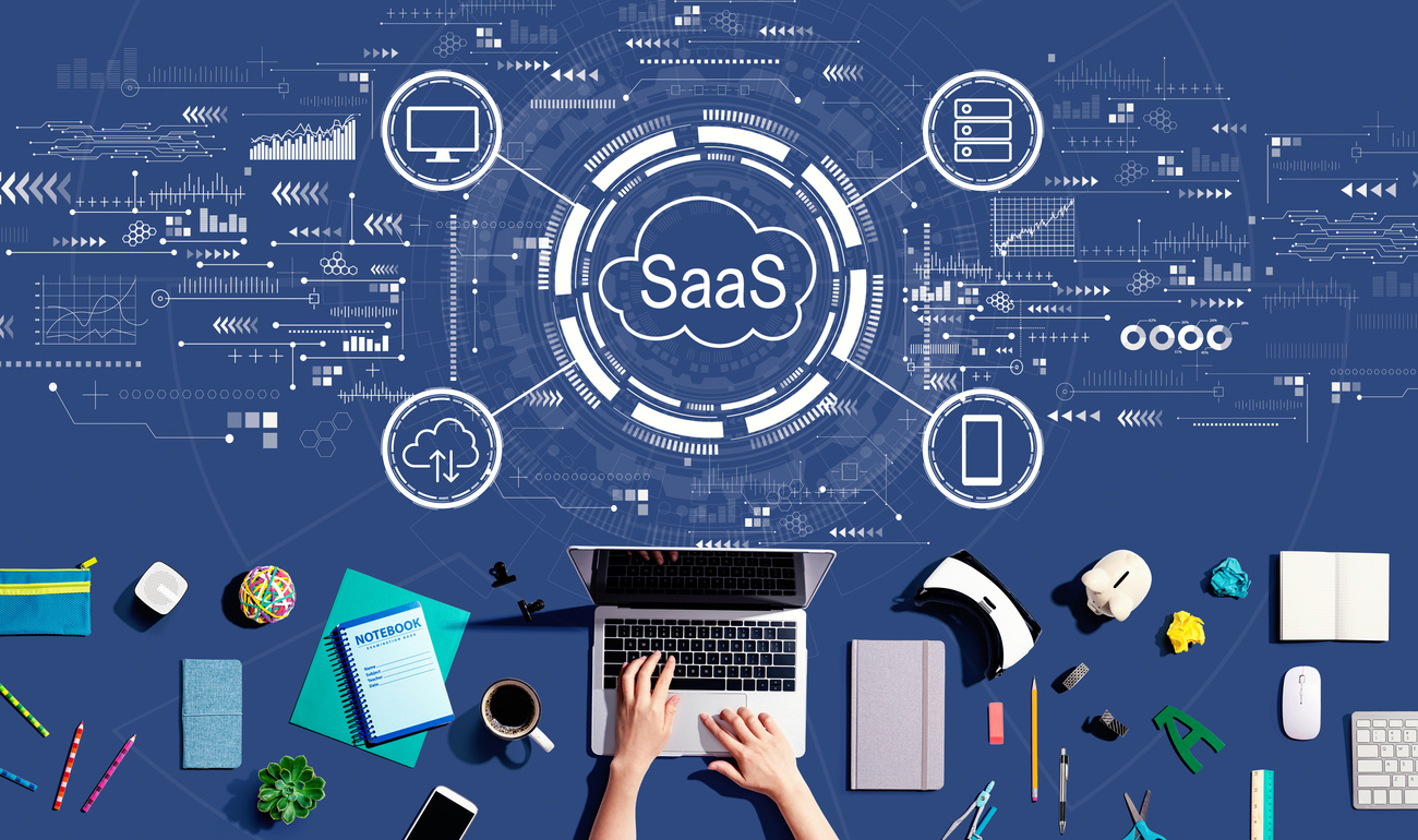 SaaS - software as a service concept with person using a laptop